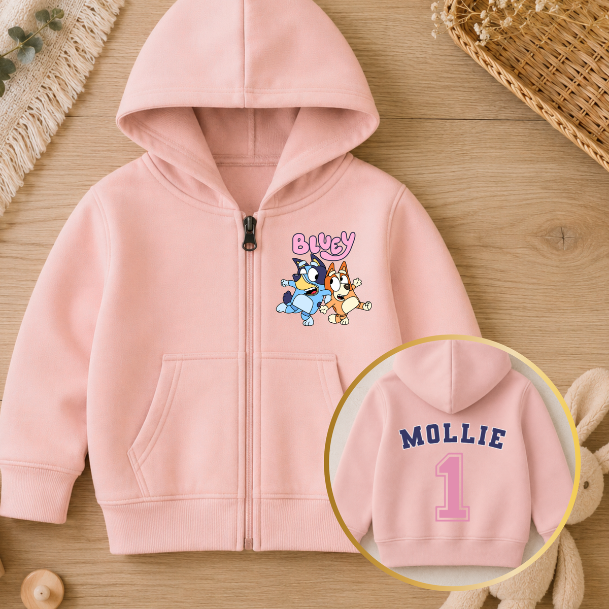 Personalised Girls Birthday Hoodie featuring Bluey and Bingo on the front, with your child's name and birthday age in a pink varsity-style design on the back.