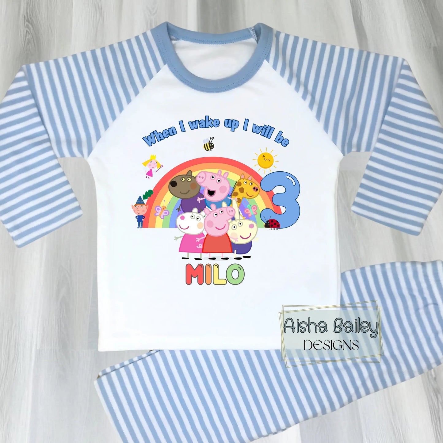 Blue Peppa Pig and friends personalised girls birthday pyjamas featuring a rainbow design and the text “When I wake up I will be with custom age and name, printed on a soft long-sleeve top and matching pink bottoms. Perfect personalised Peppa Pig birthday outfit for toddlers, ideal for first second third birthday celebrations, gifts, and bedtime photos.