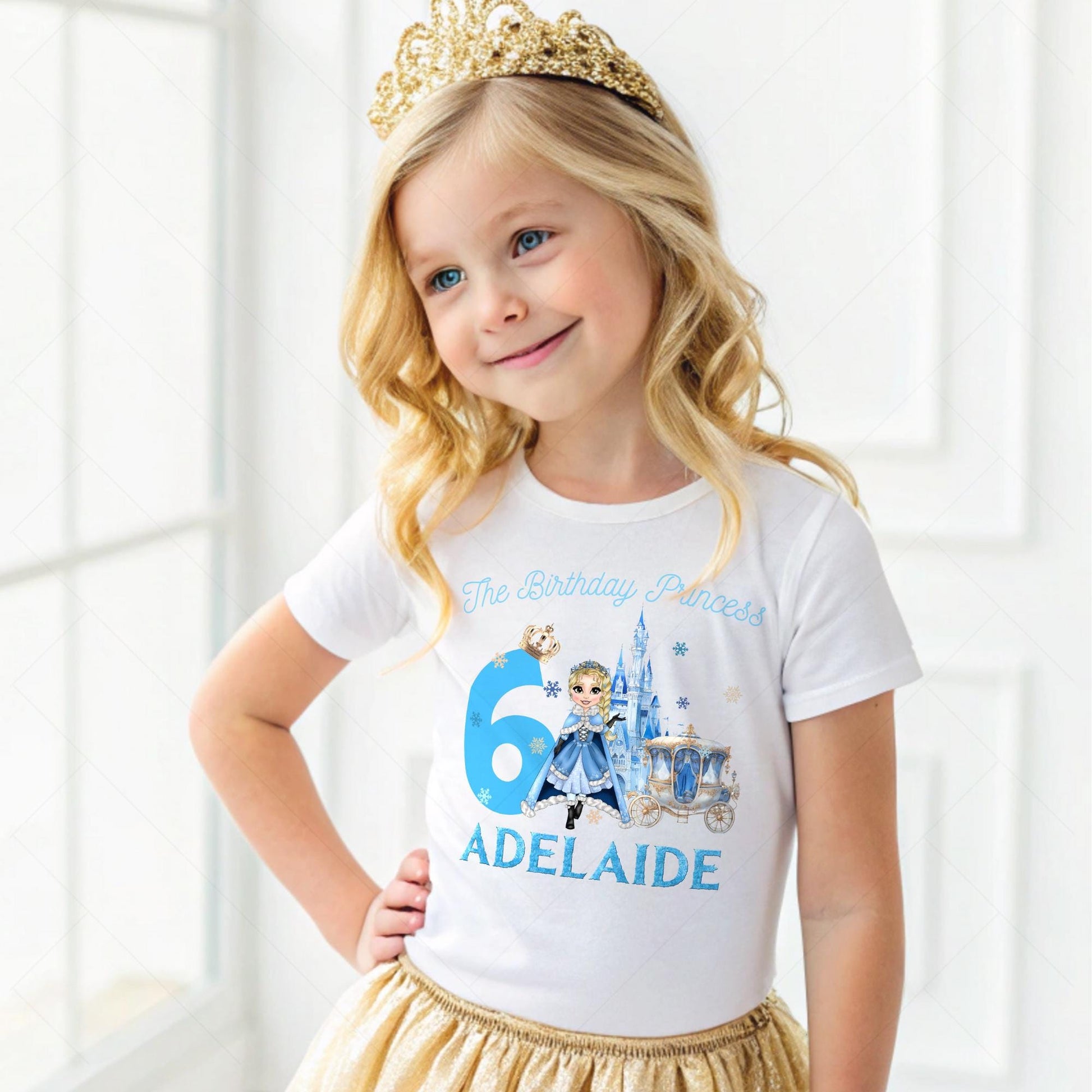A charming, personalized girls&#39; birthday T-shirt designed for a princess-themed celebration. The design is a soft blue, reminiscent of an ice princess&#39;s gown, crafted from 100% cotton for comfort. Its front features a delightful illustration of a snow princess, surrounded by delicate snowflakes. The design is completed with customizable elements, displaying a name and age in elegant, white script. This tee is perfect for creating a magical birthday experience for any young princess.